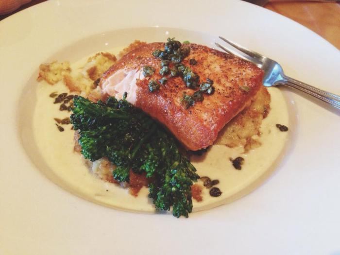 Wild salmon on a bed of organic broccolini, and potato croquettes in a creamy garlic sauce.